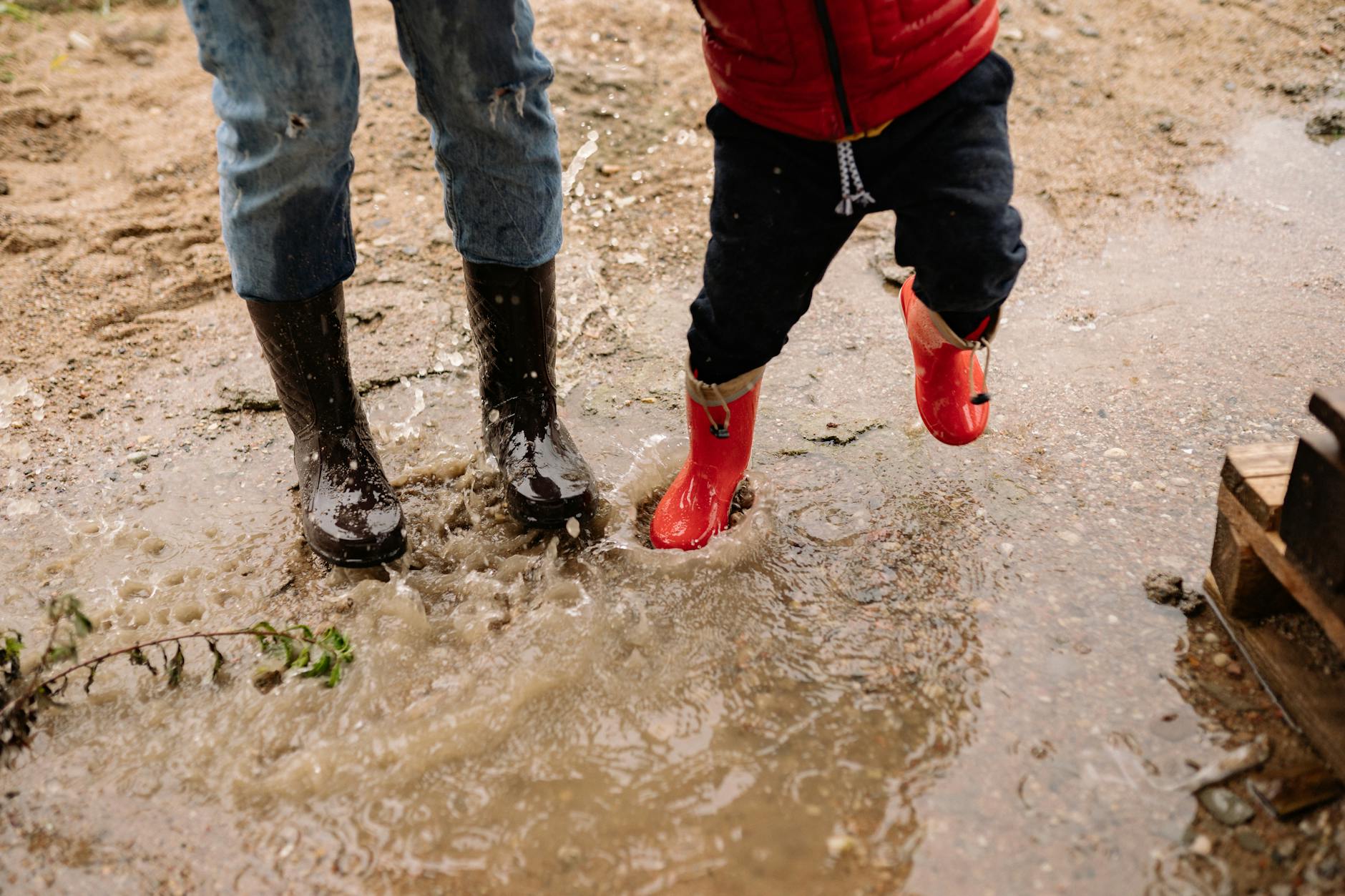 Adventure motorcycle boots covered in mud after off-road riding