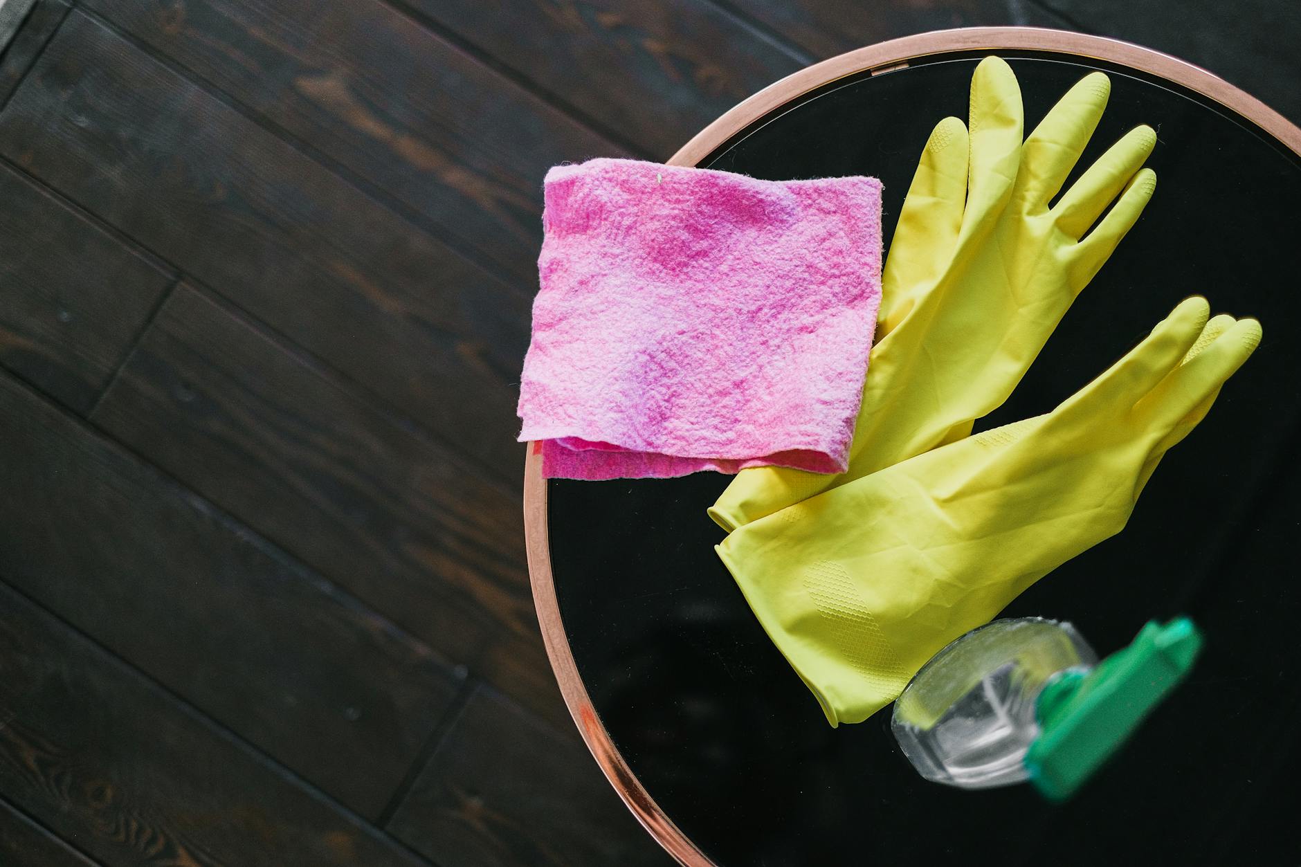 Close-up of hands applying conditioner to ladies motorcycle gloves