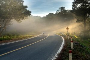 Motorcyclist wearing protective motorcycle pants on a scenic highway ride