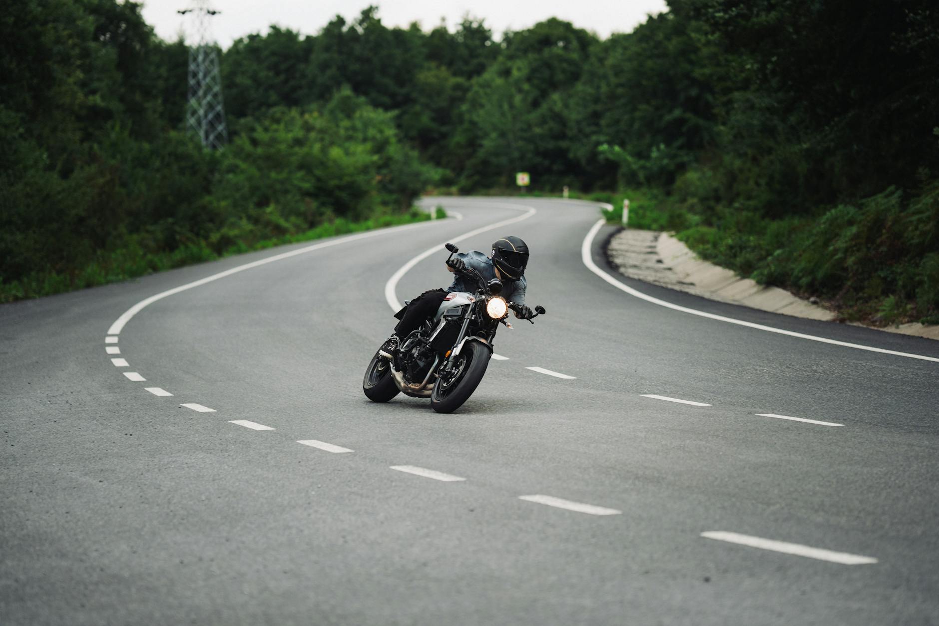Rider demonstrating flexibility of ladies motorcycle pants while cornering
