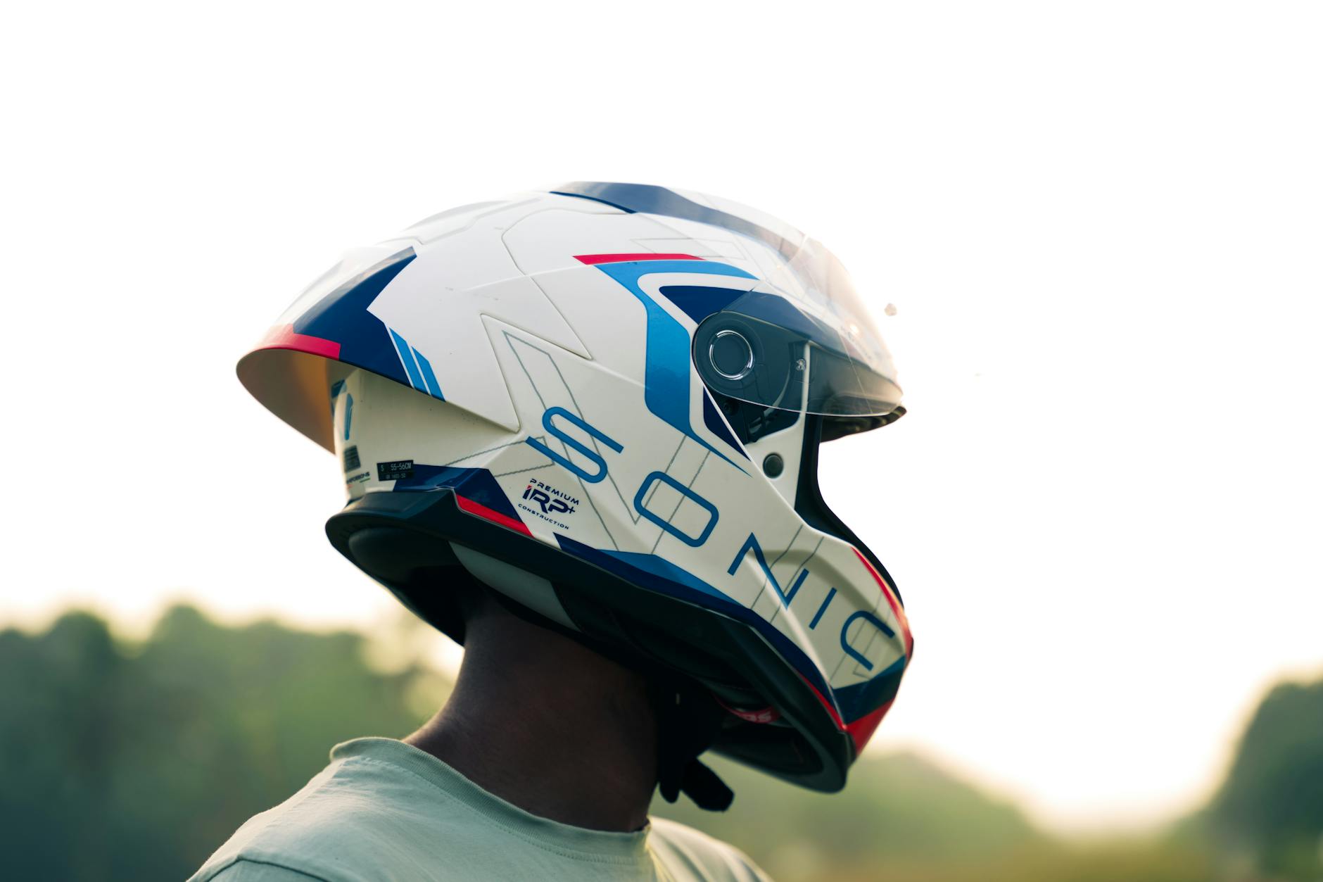 Motorcycle rider performing final helmet fit check before riding