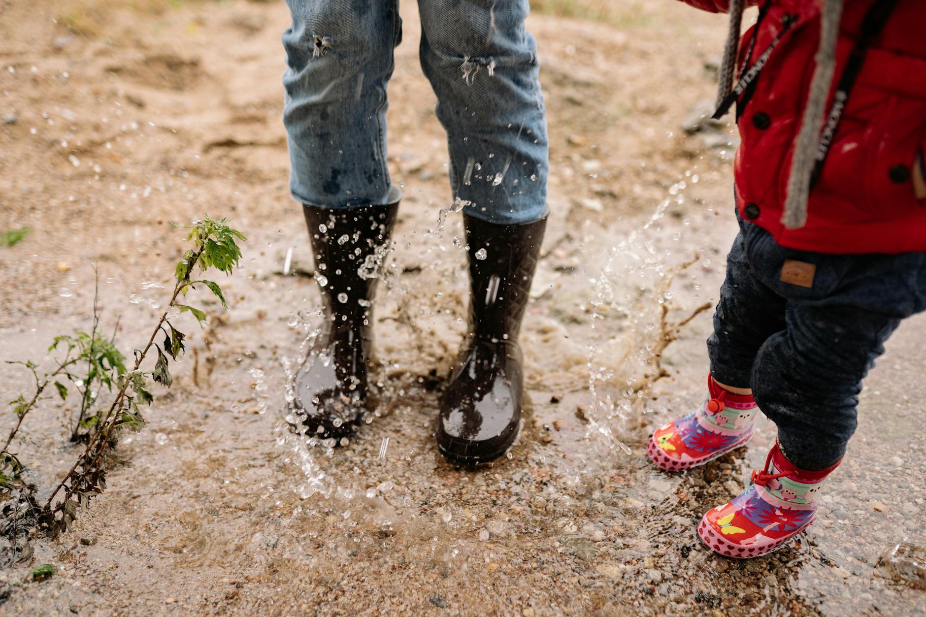 A rider wearing waterproof motorcycle boots in heavy rain