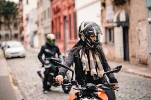 Confident woman wearing ladies motorcycle pants while riding on scenic highway