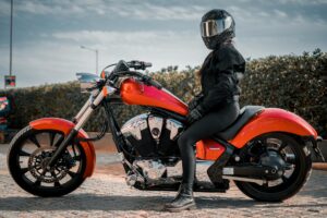 Confident woman wearing motorcycle pants women's on a scenic ride