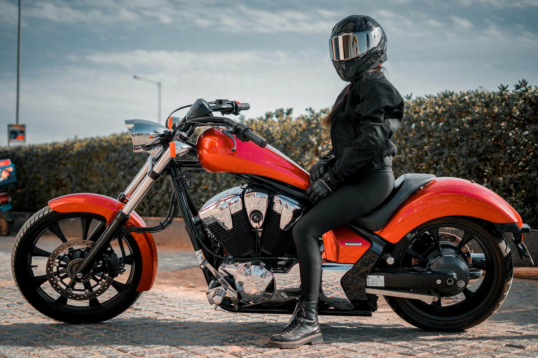 Confident woman wearing motorcycle pants women's on a scenic ride
